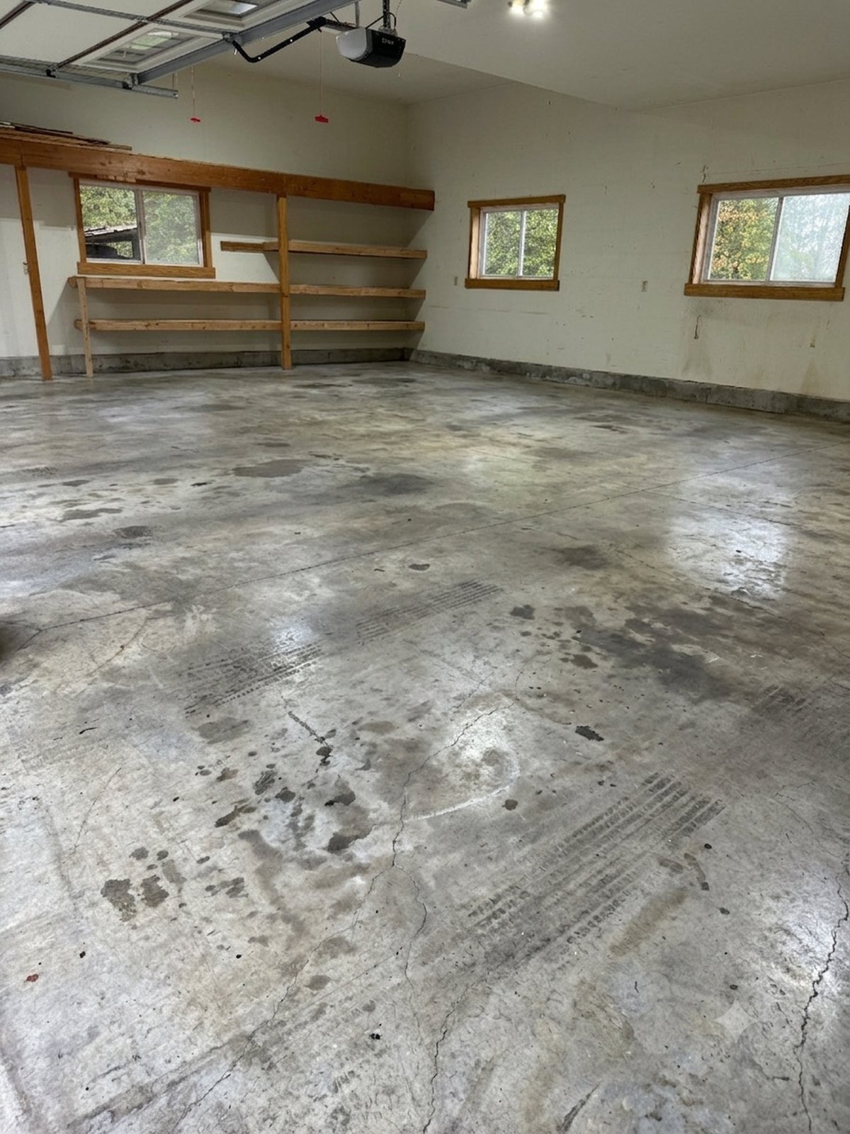Before: bare stained concrete garage floor