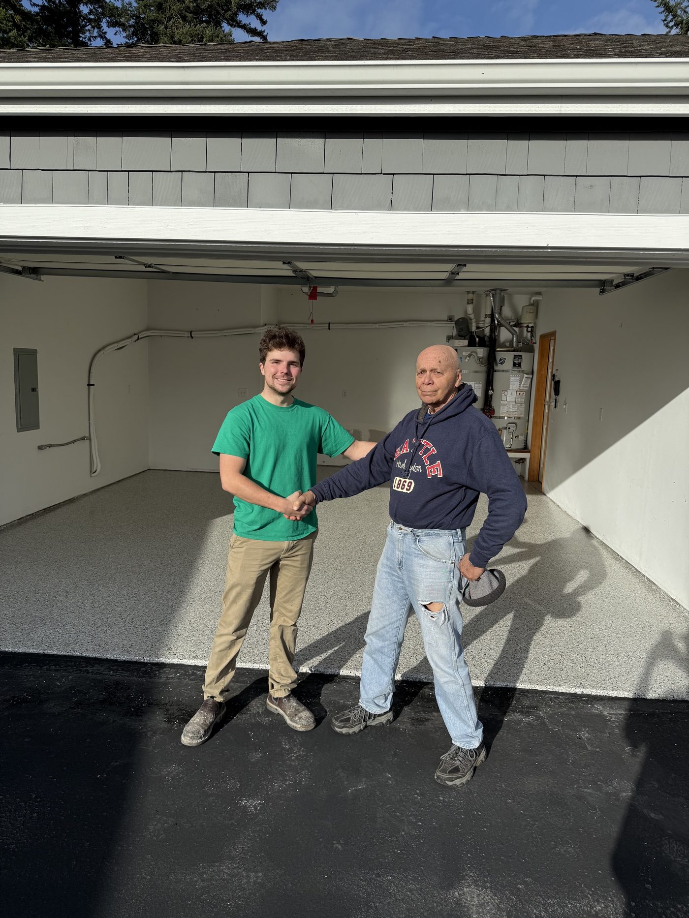 Evergreen Epoxy owner shaking hands with a customer on their new garage floor