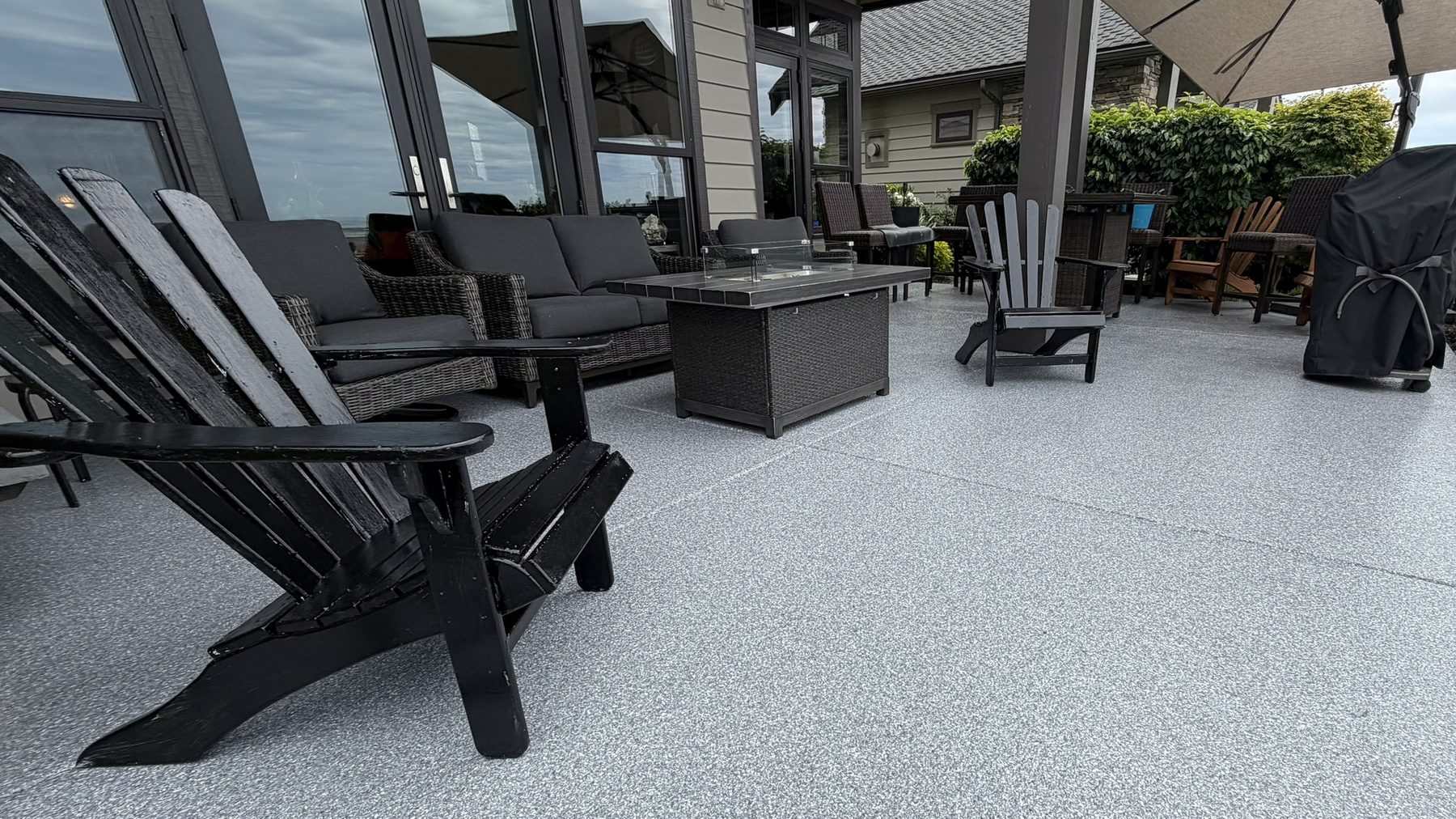Covered flake patio with fire table and a view